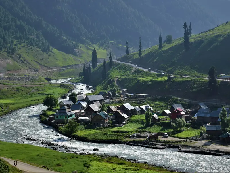 Houses and fields set against mountains